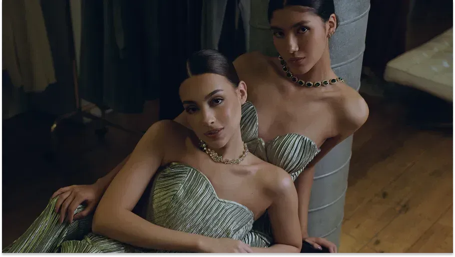 Two models in metallic strapless dresses