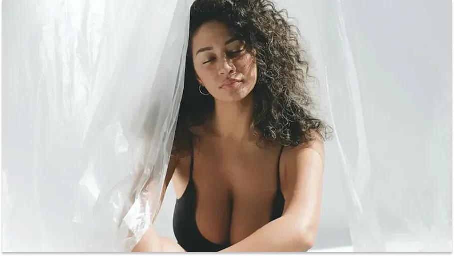 Woman with curly hair posing softly