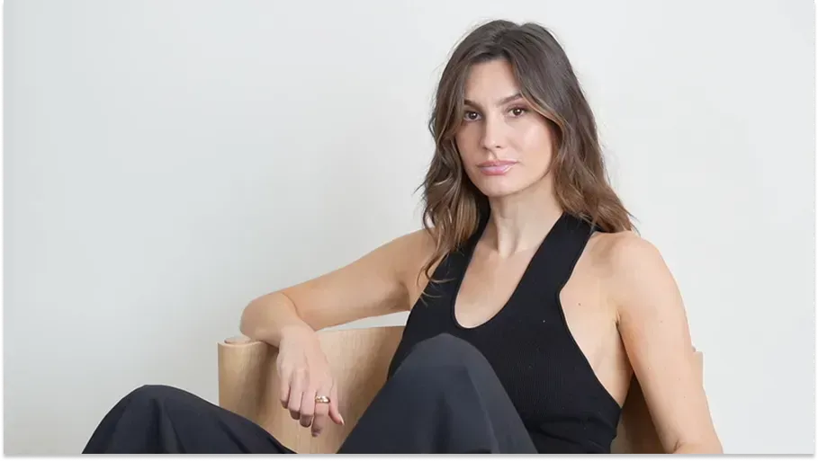 Woman in a black top sitting by the light