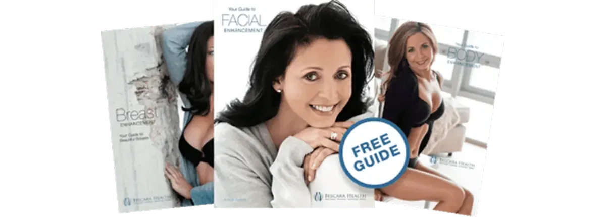Three brochures featuring a smiling woman in a gray sweater. The left brochure is titled 'Your Guide to Breast Enhancement', the middle one reads 'Your Guide to Facial Enhancement', and the right one states 'Your Guide to Body Enhancement'.