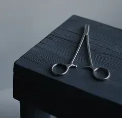 Surgical scissors on a wooden surface