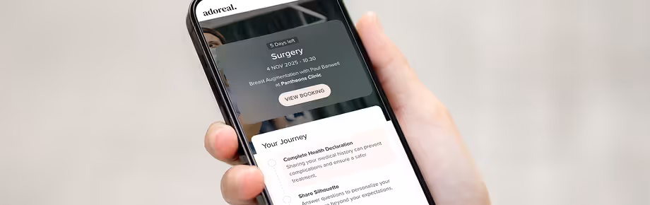 A mobile phone showing the Adoreal booking flow