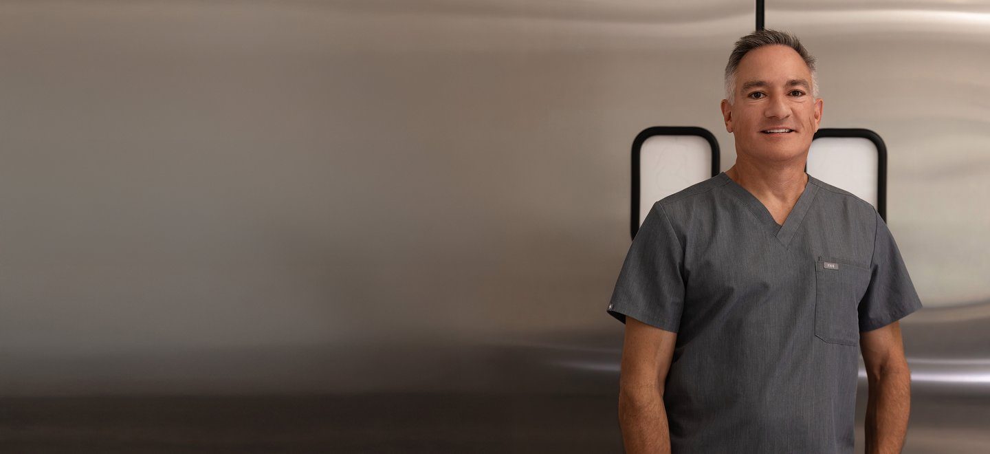 Dr. Kent V. Hasen in surgical scrubs at his Naples practice