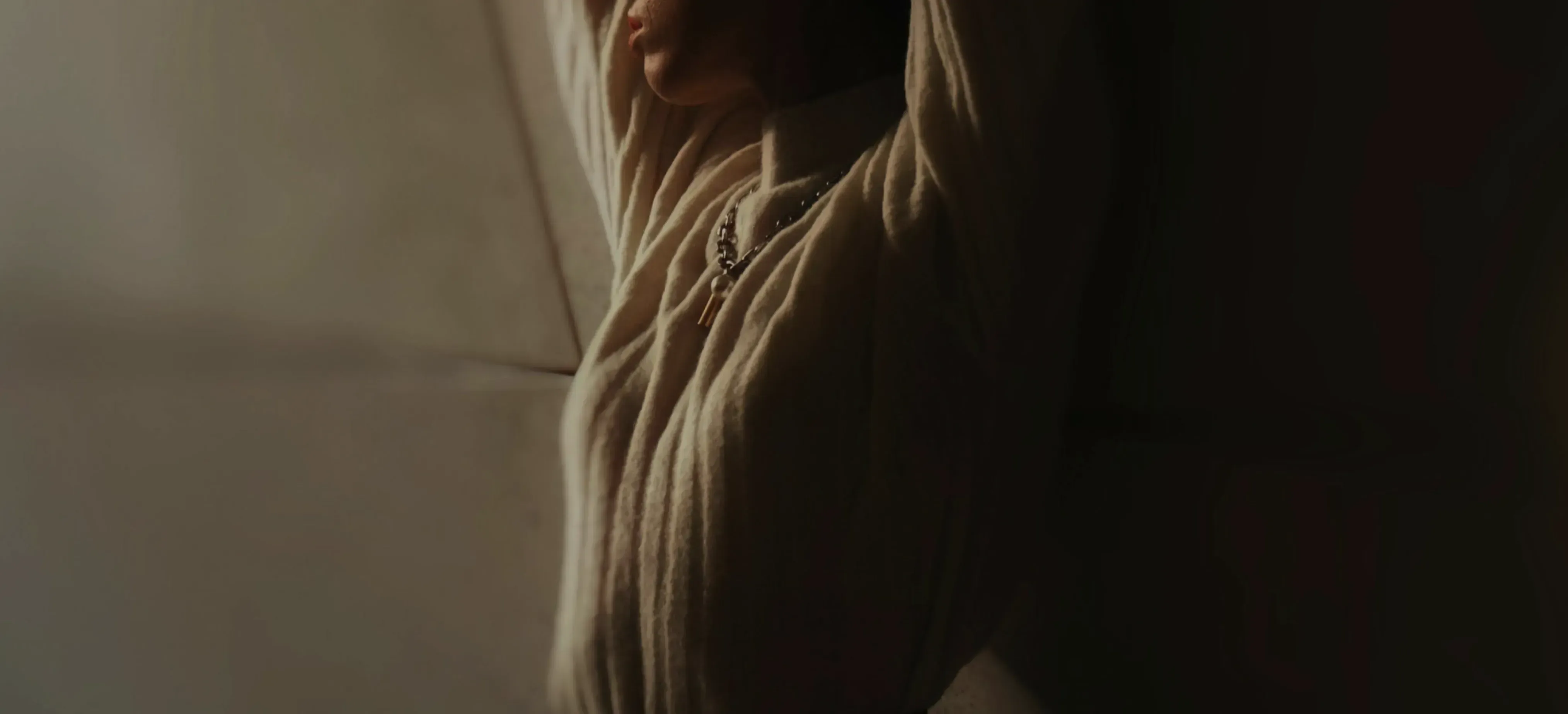 Woman in soft light looking over her shoulder