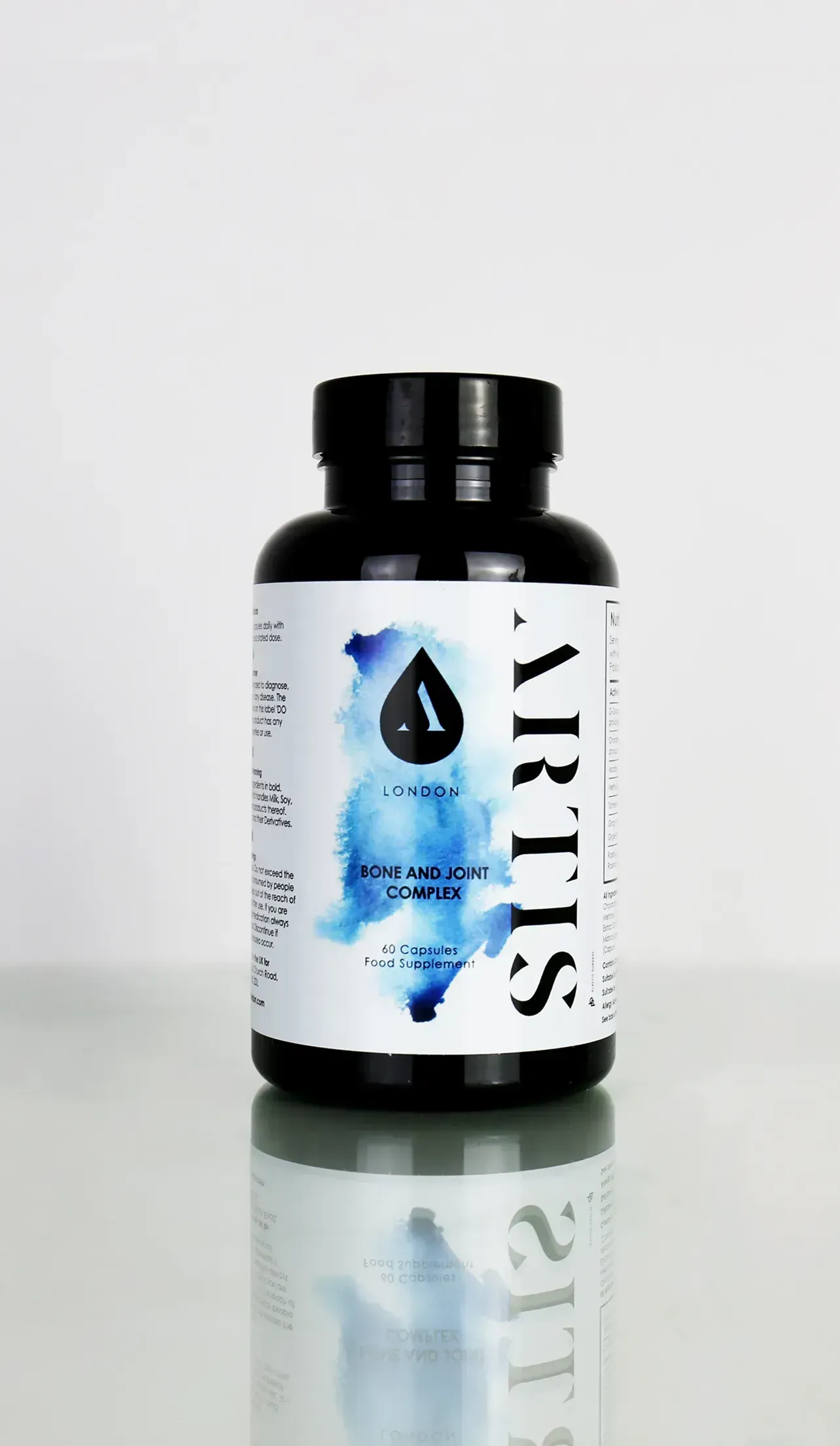 A bottle of vitamins sits on a reflective surface