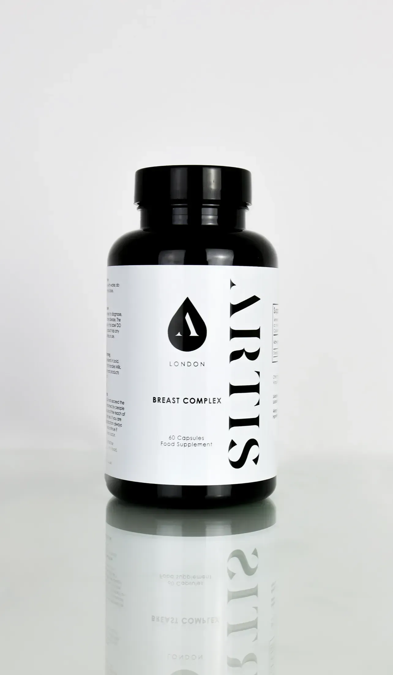 A bottle of vitamins sits on a reflective surface