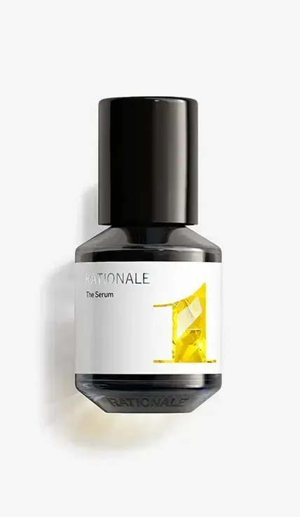 A bottle of yellow liquid sitting on top of a white wall