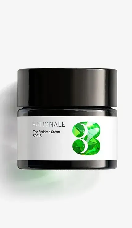 A jar of green tea cream on a white background
