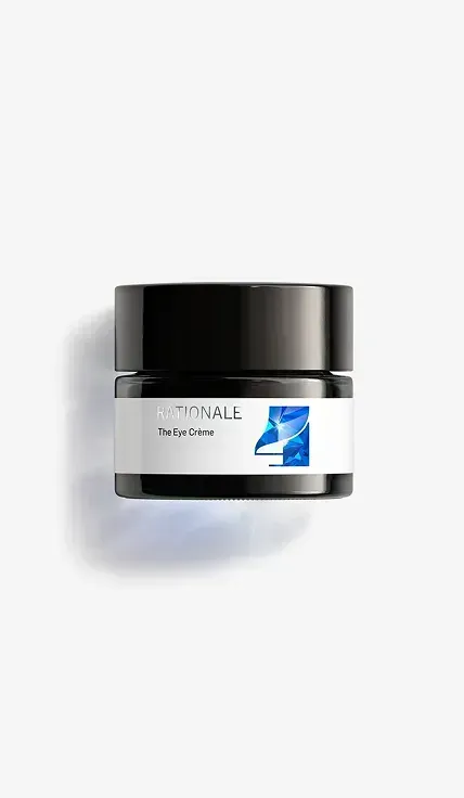 A white jar with a black lid sitting on a white surface